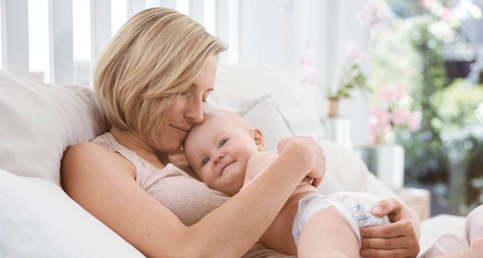 A woman is holding a baby.