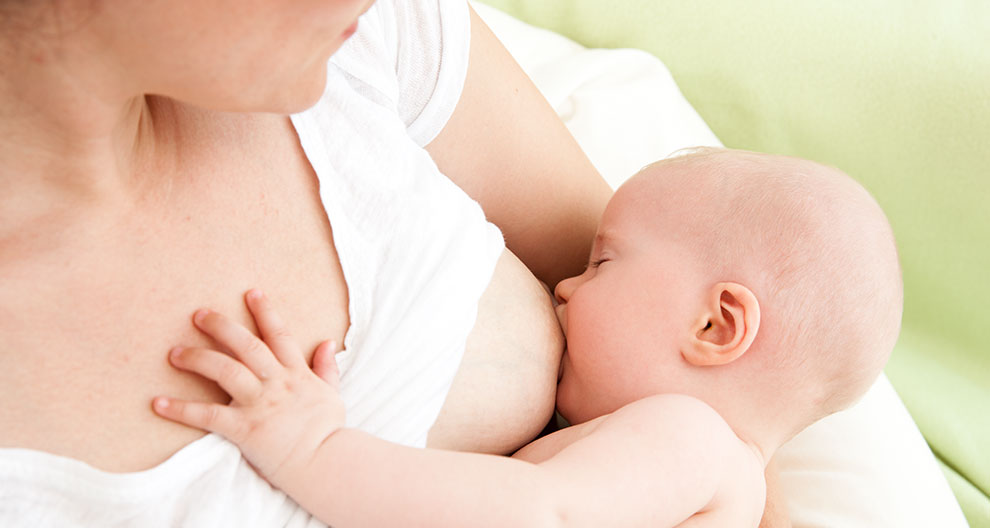 A mother breastfeeds her baby.